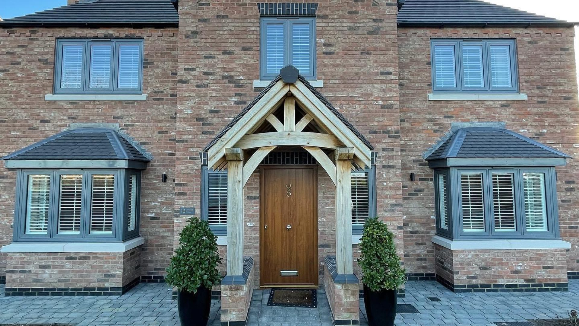 House with a driveway and built porch area