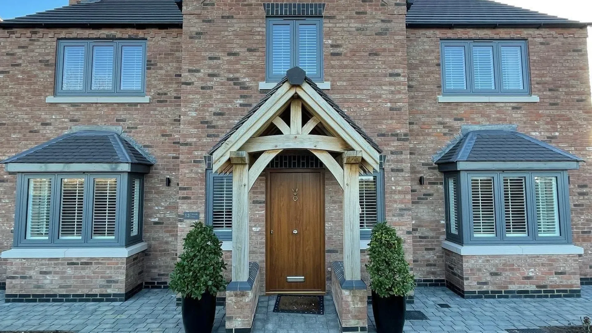 House with a driveway and built porch area
